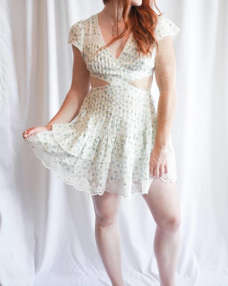 Front of a model wearing a size L Lace Flutter Sleeve Mini Dress In White in White by MABLE. | dia_product_style_image_id:346829